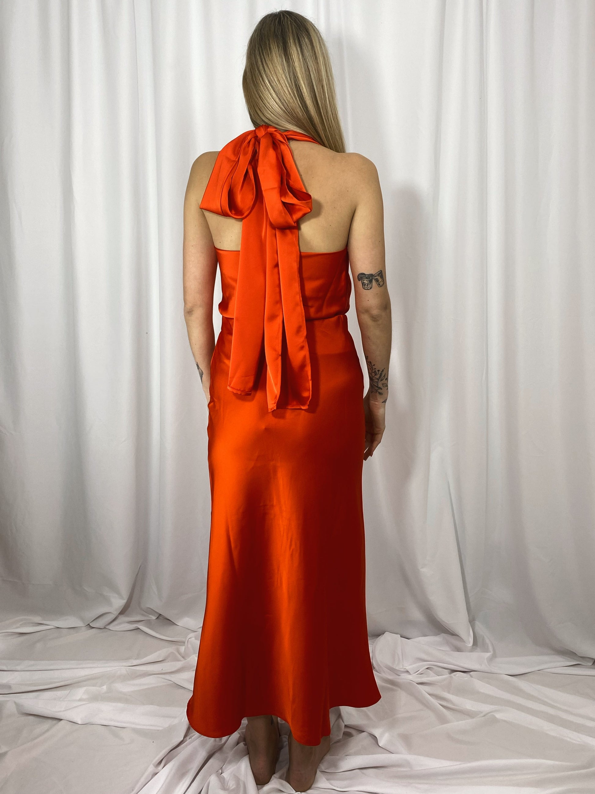 Jupe Capucine rouge orangé portée avec haut assorti en satin
